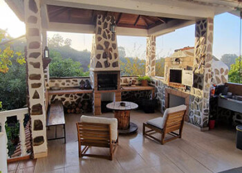 The cozy fire pit / BBQ area and stone pizza wood oven.